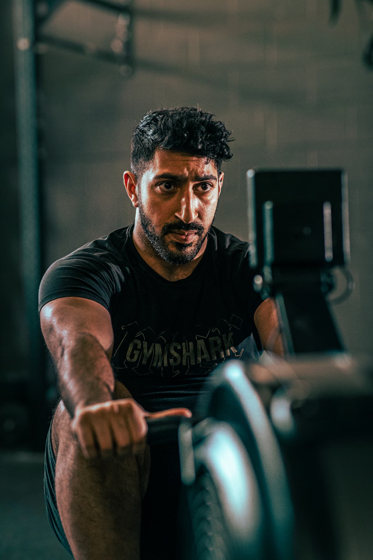 Athlete training on a rowing machine during a fitness campaign
